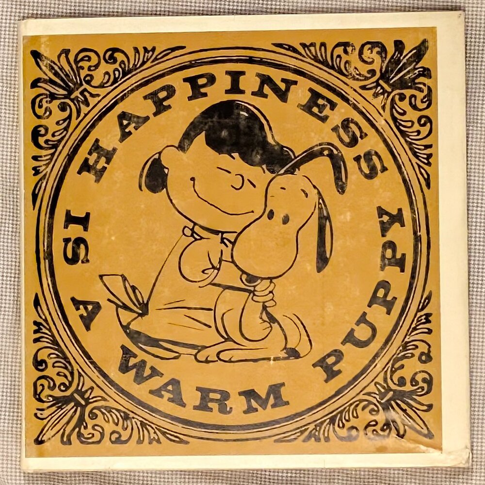 HAPPINESS IS A WARM PUPPY, BY CHARLES SHULTZ,1962